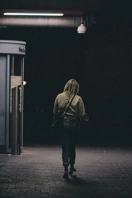 Woman walking in dark area